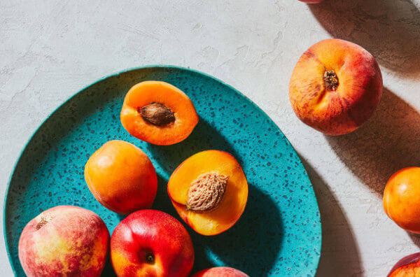 Персики, нектарини та абрикоси на тарілці